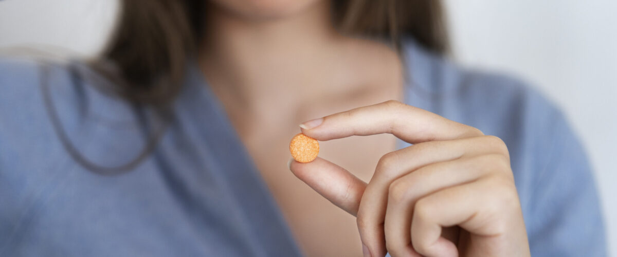 front-view-woman-holding-pill